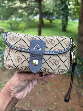 Dooney & Bourke Beige and Brown Monogram Wristlet Clutch With Blue Duck Charm
